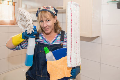 Portrait of smiling woman standing at home