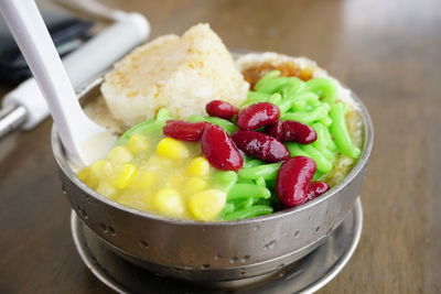 High angle view of chopped fruits in bowl on table