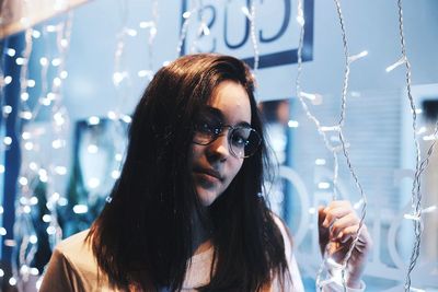 Close-up portrait of young woman in sunglasses