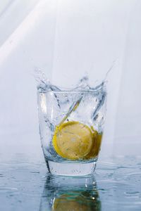 Close-up of drink in glass against water