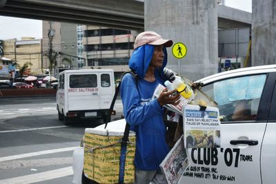 Man working on street in city