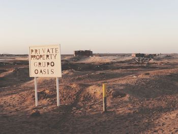 Information sign on road against clear sky