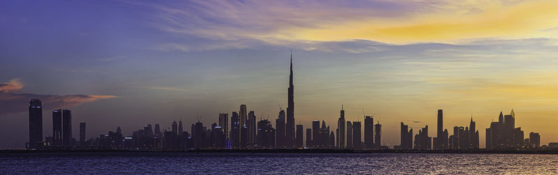 Panoramic view of modern buildings against sky during sunset