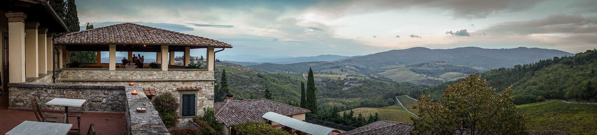 Panoramic view of townscape and mountains against sky