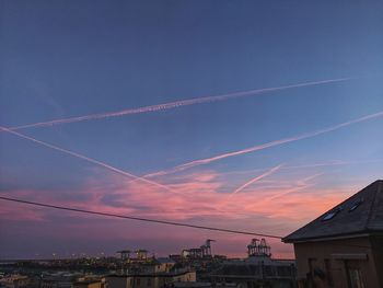 Low angle view of buildings against sky at sunset