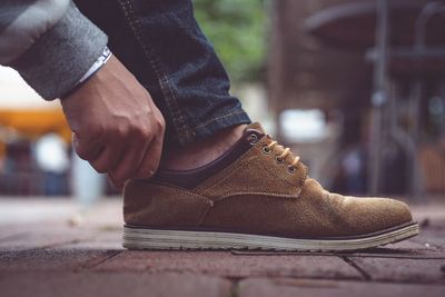 Low section of man wearing leather shoes