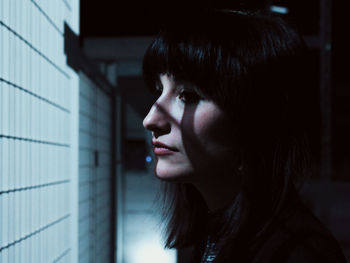 Close-up of woman looking through window