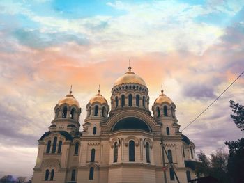Low angle view of building against sky during sunset