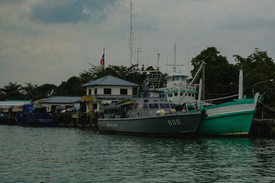 Boats moored in sea against sky