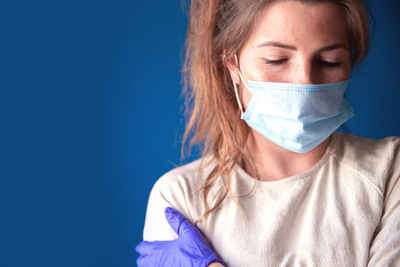 Portrait of a beautiful young woman over blue background