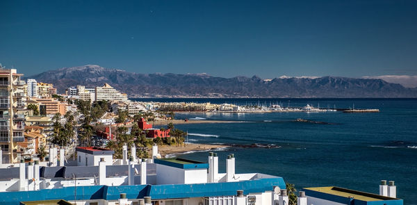 Scenic view of buildings by sea against mountains at costa del sol