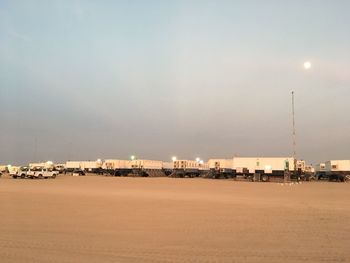 Scenic view of beach against sky at dusk