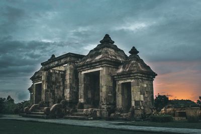 Low angle view of historic building against cloudy sky