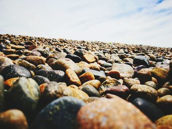 Close-up of pebbles on beach against clear sky