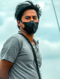 Portrait of man standing against sky