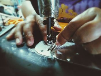 Close-up of person working on machine