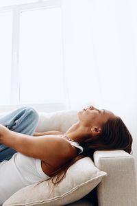 Young woman lying on bed at home