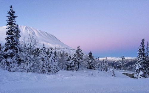 Scenic view of snow covered landscape against clear sky