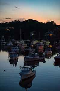 Sunset over a boat harbor in maine.