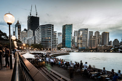 Group of people in city against buildings