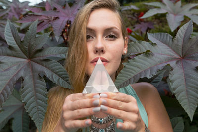 Close-up portrait of beautiful woman holding crystal