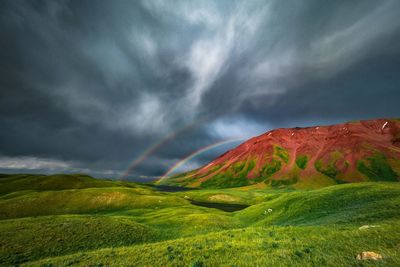 Scenic view of mountain against cloudy sky