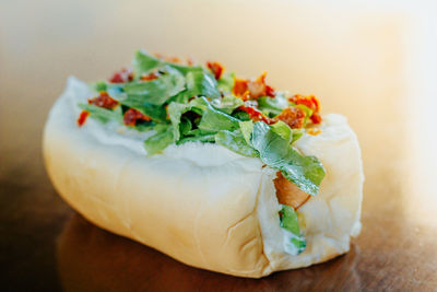 Close-up of vegetarian hot dog served on table