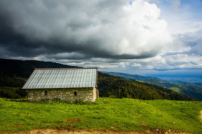 Built structure on field against sky