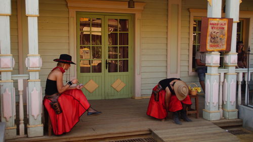 Women in traditional costume at porch