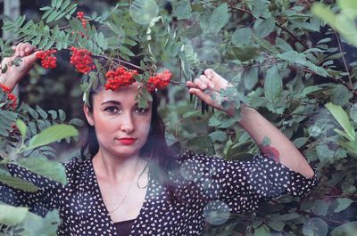 Portrait of beautiful woman with red flower