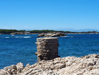 Scenic view of sea against clear blue sky