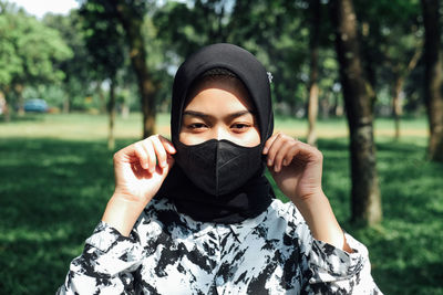 Portrait of a young woman covering face