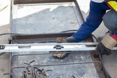 High angle view of man working on metal