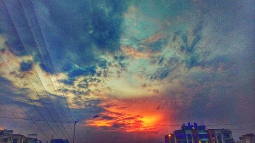 Low angle view of dramatic sky over city