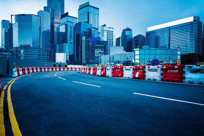 View of city street and buildings against sky