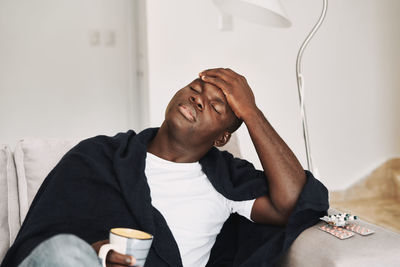 Midsection of man sitting at home