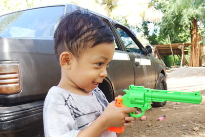 Portrait of cute boy holding camera