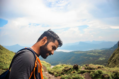 Portrait of young man against mountains