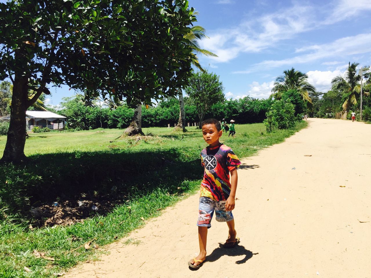 tree, full length, childhood, one person, outdoors, grass, real people, day, nature, sky, people