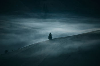 Mountain against cloudy sky