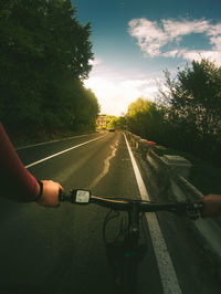 Man riding motorcycle on road against sky