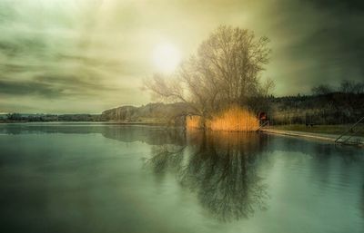 Scenic view of lake against sky at sunset