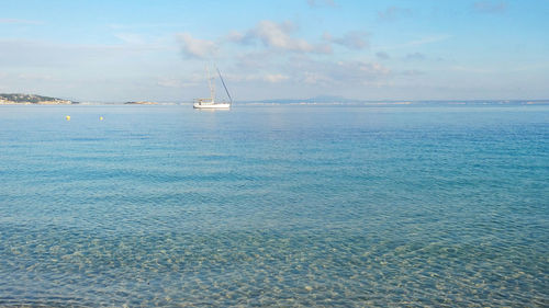 Sailboat in sea against sky