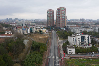 High angle view of city buildings against sky