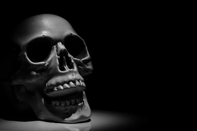 Close-up of human hand against black background