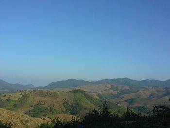 Scenic view of mountains against clear blue sky