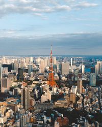 Aerial view of buildings in city against sky