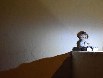 Boy sitting against wall