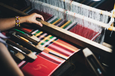 Close-up of hand working on loom