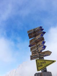 Low angle view of road sign against sky